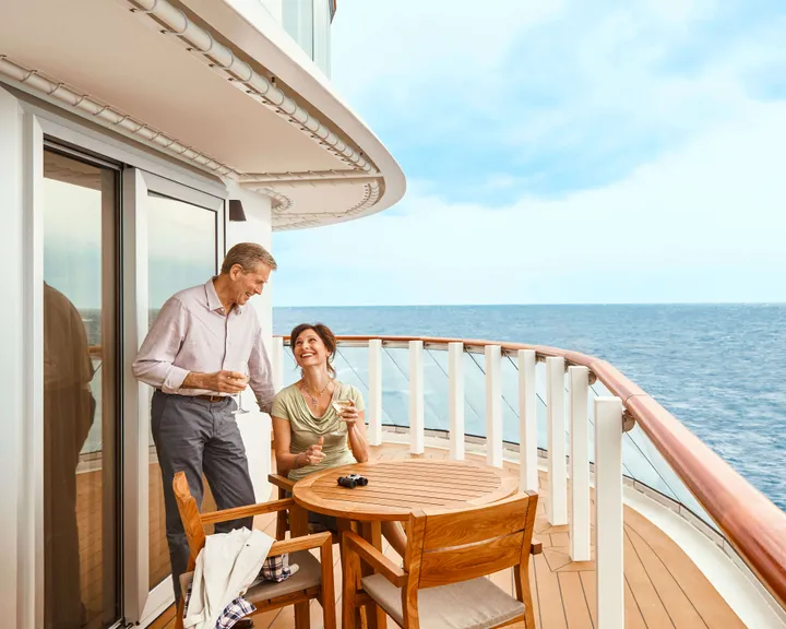 A couple sits on the veranda in an Explorer Suite