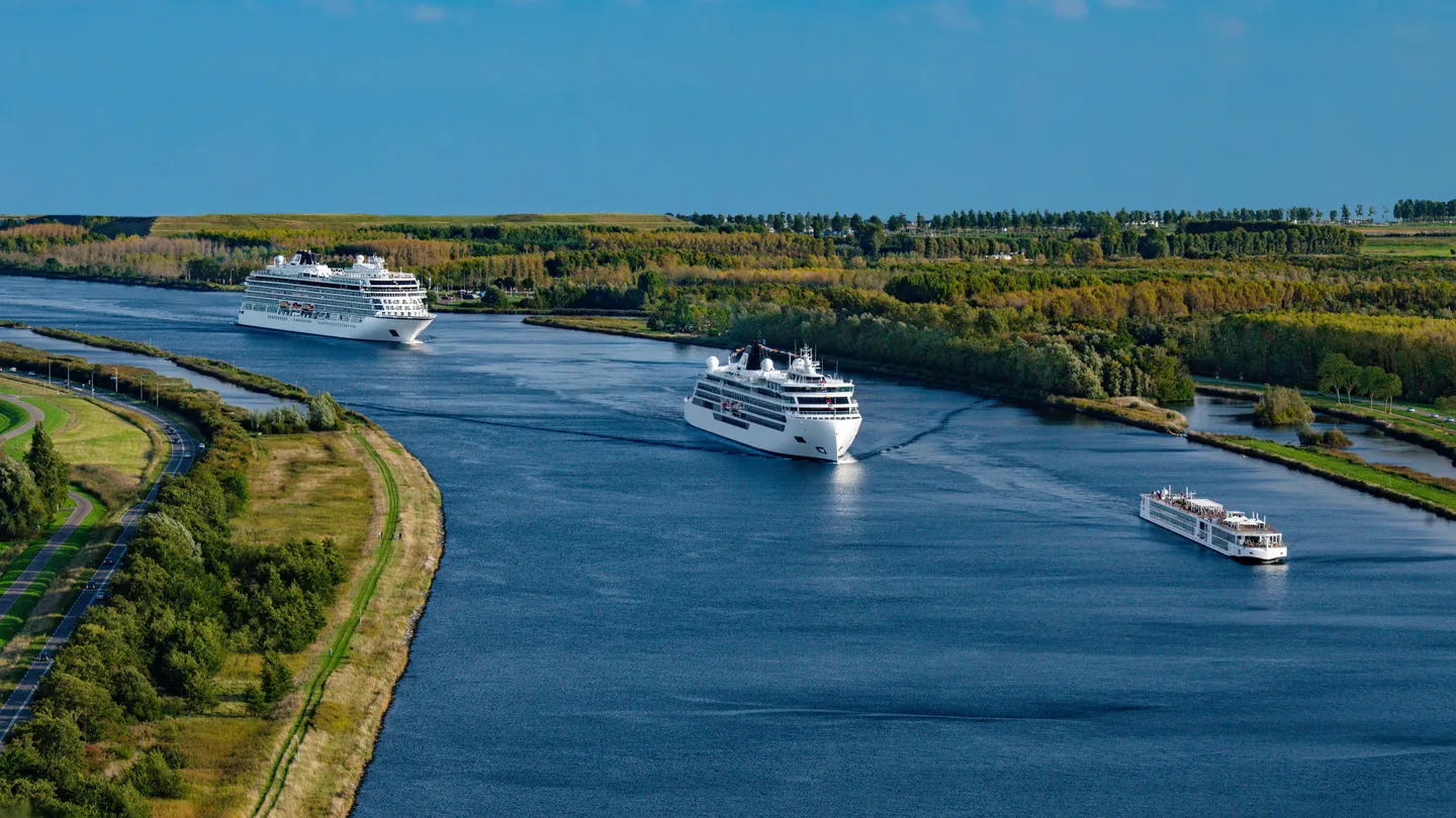 Three ships sailing in a convoy on the water
