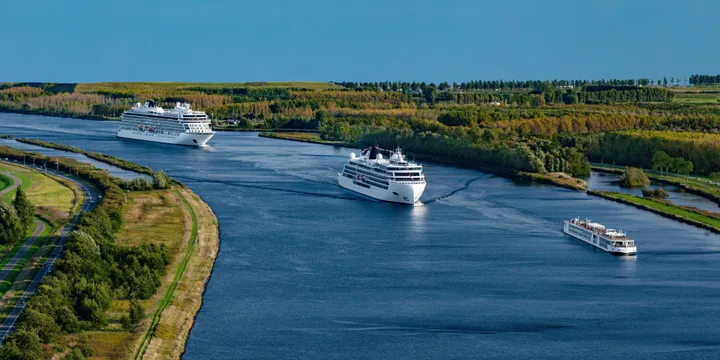 Three ships sailing in a convoy on the water