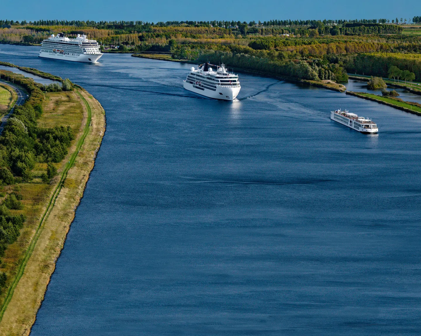Three ships sailing in a convoy on the water