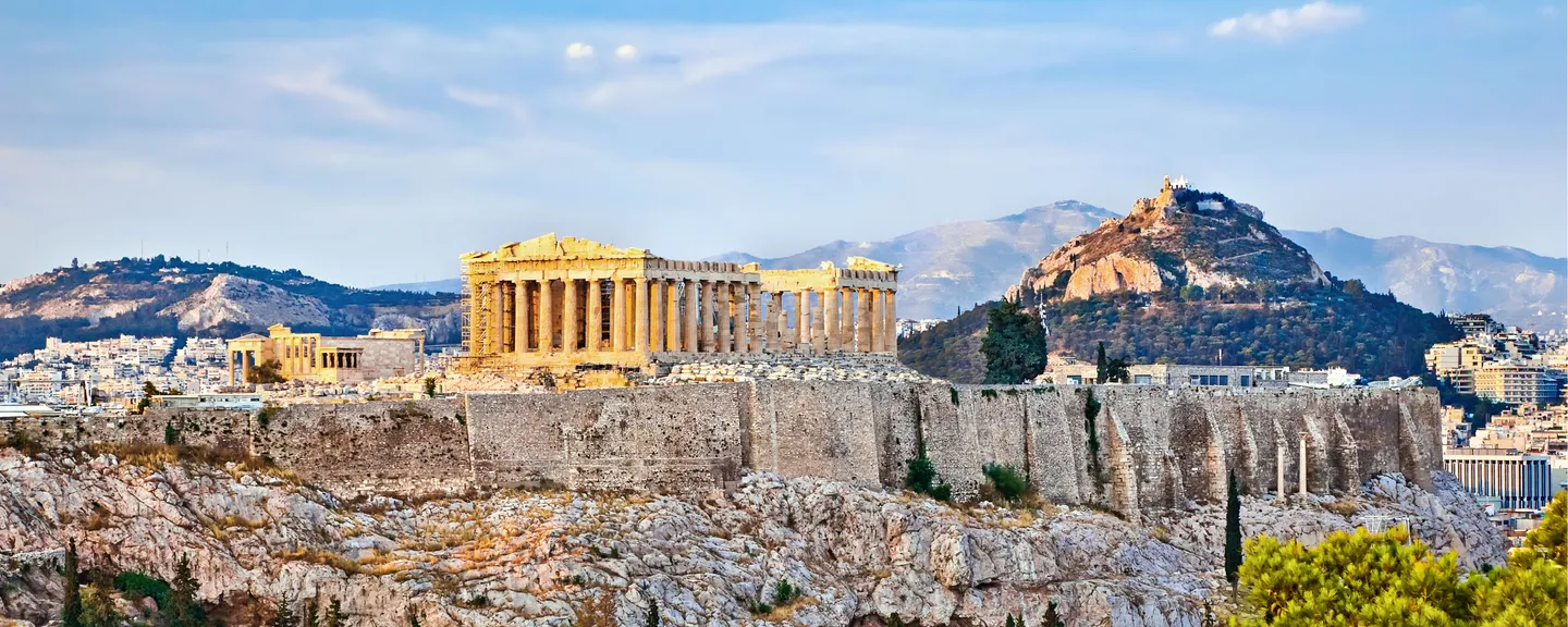 The Acropolis with a cityscape and hills in the background