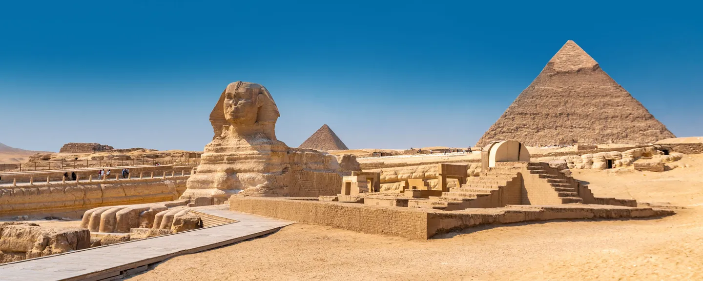 The Great Syphinx statue with the Great Pyramid of Giza in the background