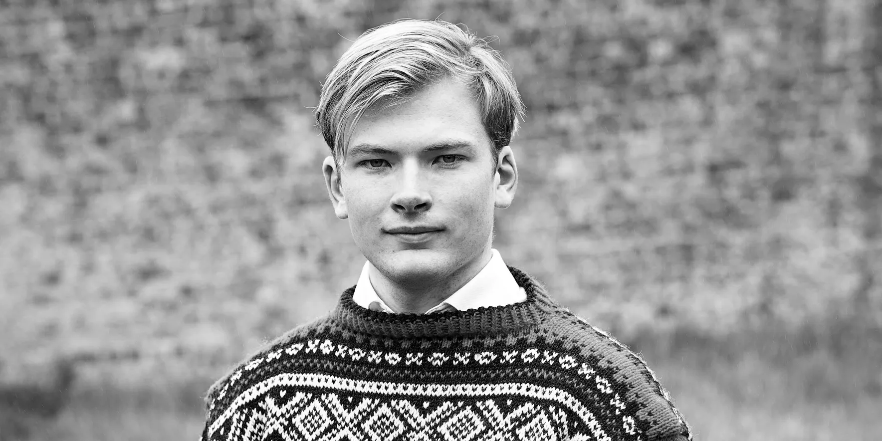 Man in patterned sweater outdoors