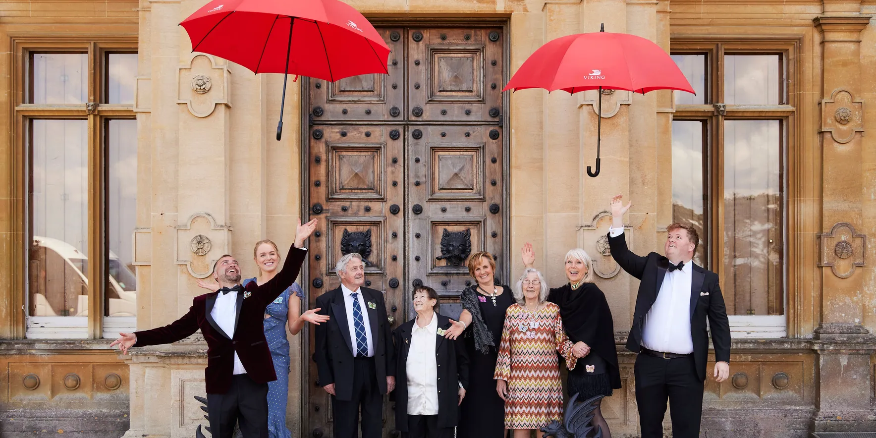 Group celebration with red umbrellas outdoors