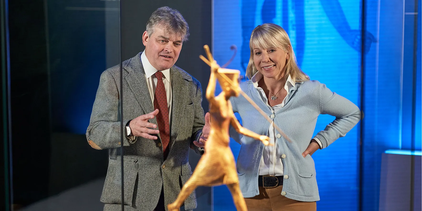 Museum visitors admire ancient sculpture