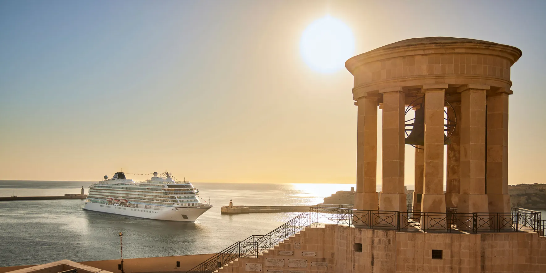 Cruise ship near historic waterfront at sunset
