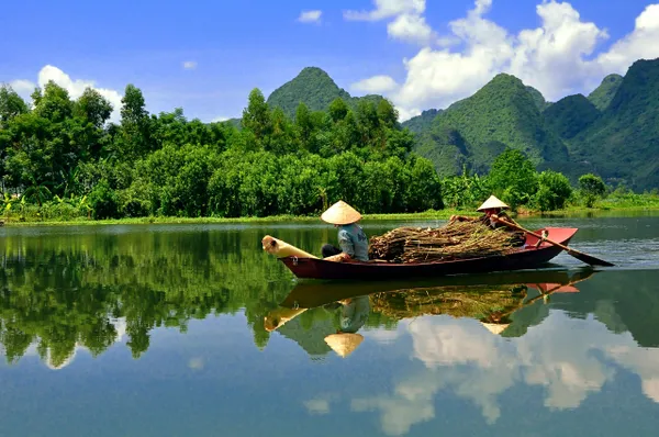 Traditional boat on serene mountain river