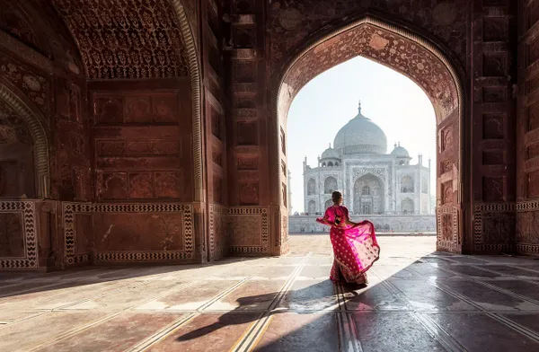 Woman in vibrant sari at Taj Mahal