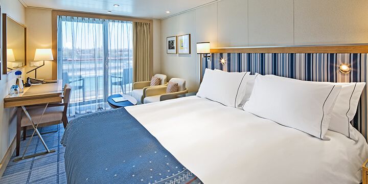 Bed in a Deluxe Veranda stateroom