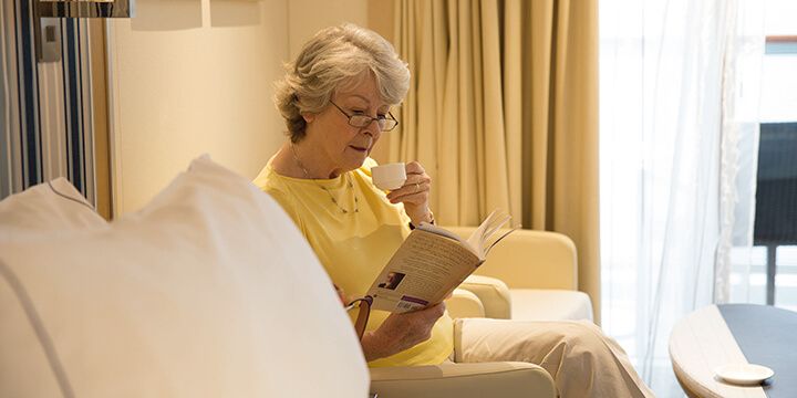 Woman reading a book in the Deluxe Veranda