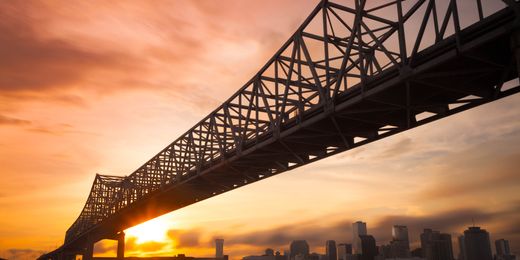 New Orleans skyline and bridge at dusk